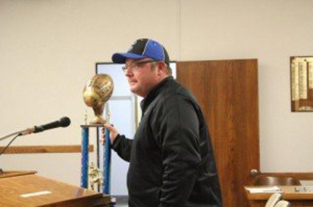 Coach Todd Oldham displays the Championship trophy that Team Us 11/12 year old traveling football team from Price won in Mesquite Nov 23