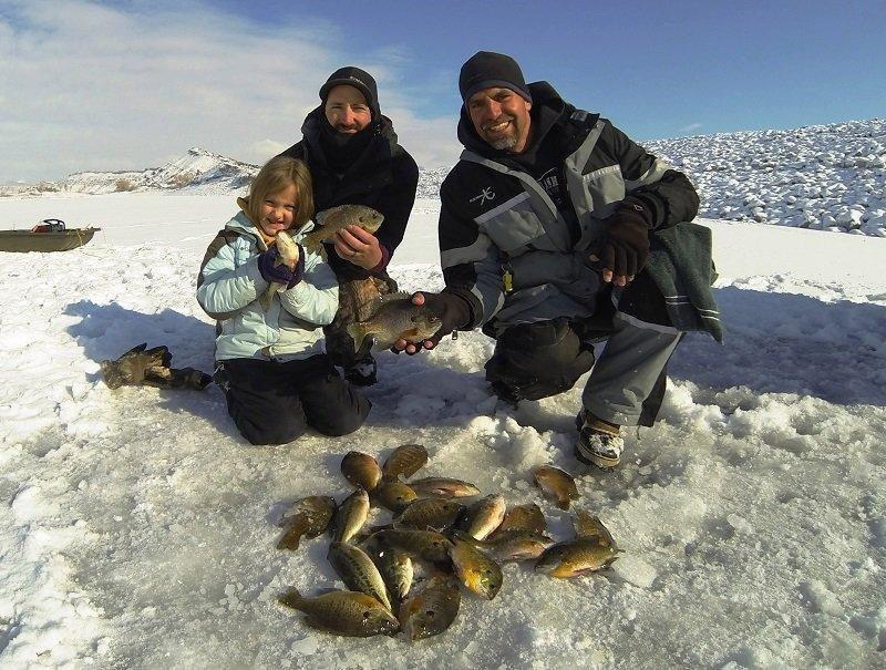 ryan_mosley_12-30-2015_ice_anglers_show_bluegill_and_largemouth_bass_they_caught_at_Steinaker_Reservoir.jpg
