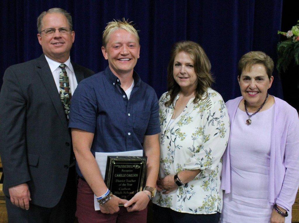Carbon-School-Board-members-Jeff-Richens-Lee-McCourt-and-Kristen-Taylor-stand-by-Teacher-of-the-Year-Cami-Carlson-during-the-Awards-Banquet..jpg