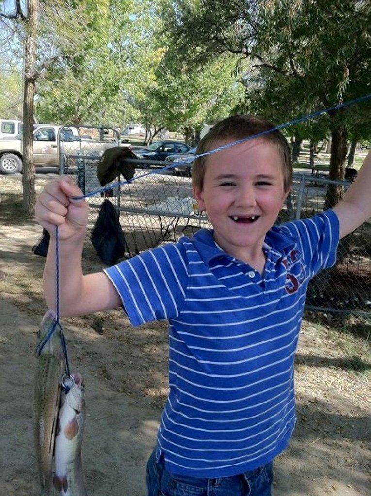 Boy-shows-off-fish-at-Green-River-fishing-event-by-B.-Stettler.jpg