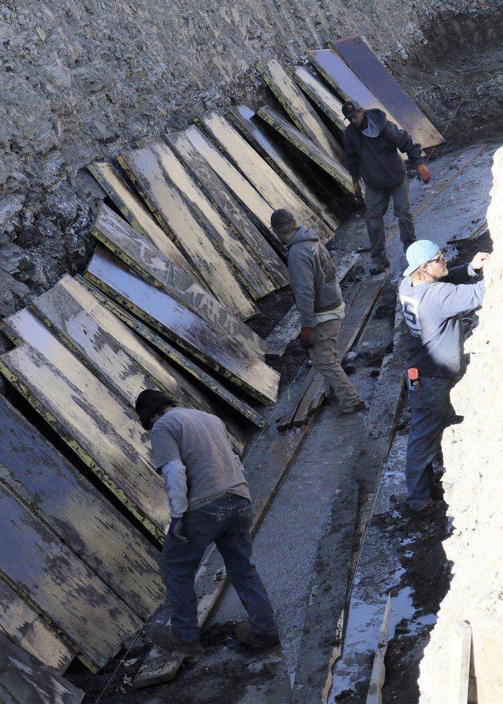 Workers-toil-to-install-reinforcements-for-retaining-wall..jpg